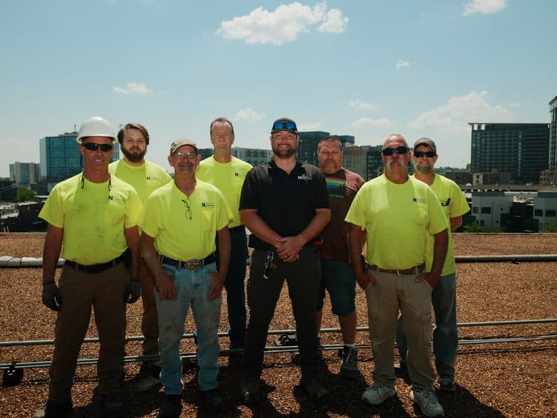 NK Mechanical crew on a commercial rooftop with the Nashville skyline
